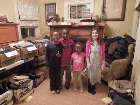 Dot steps up to aid fire victims  : Neighbors have rallied to help out 14 people displaced by a fast-moving fire that destroyed their home at 49 Mather St. on Feb. 10. Above, (l-r) youngsters Mateo, Diego, and Nia Benzan Buyu and Ella Moye-Gibbons are shown with boxes of clothing and supplies that were dropped off to the Moye-Gibbons home. A fund launched through the Dorchester House has generated nearly $4,000 to assist the survivors of the blaze. Photo courtesy Jenny Moye
